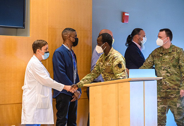 Johns Hopkins veterans congratulate the National Guard members.